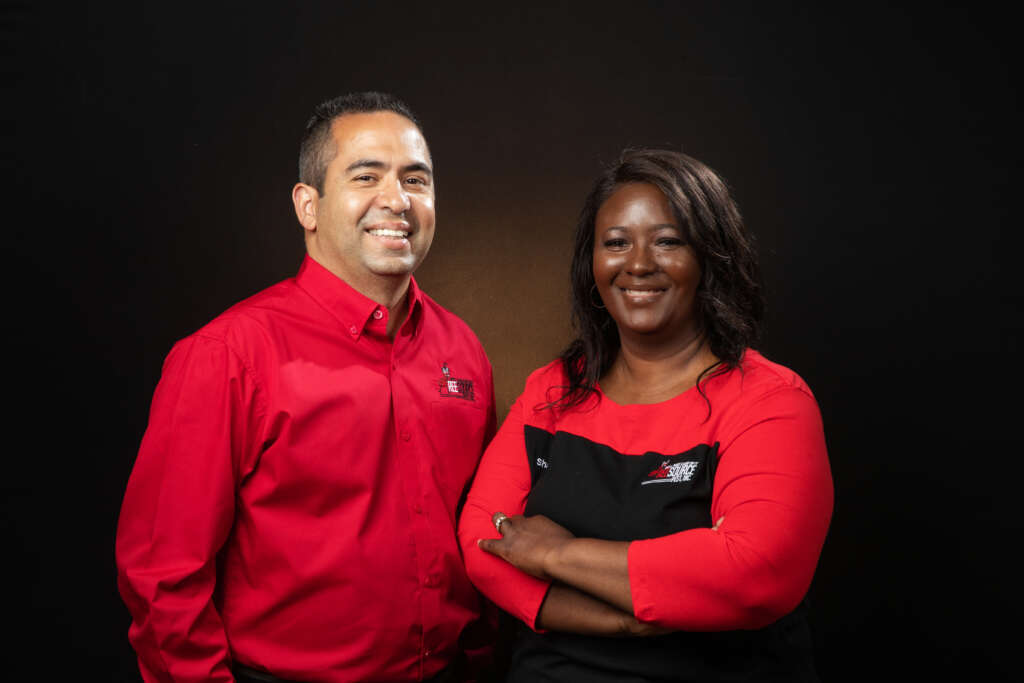 Two smiling professionals providing expert Maryland pest control services.